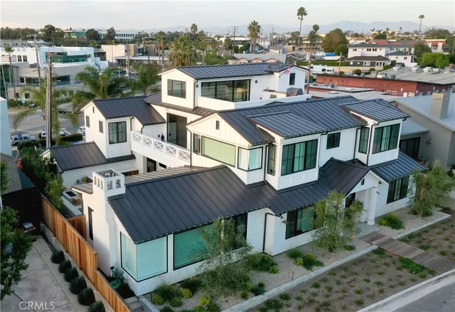 an aerial view of a house with a yard garage and lake view