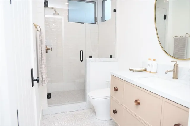 a bathroom with a sink a toilet and shower