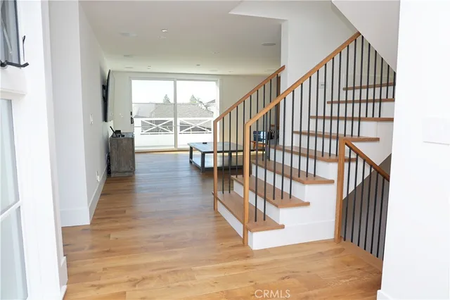 a view of staircase with wooden floor and a window