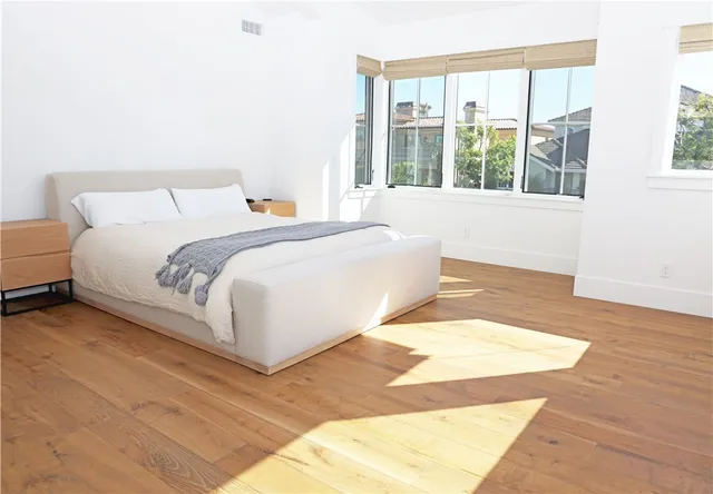 a bedroom with a large bed and a large window