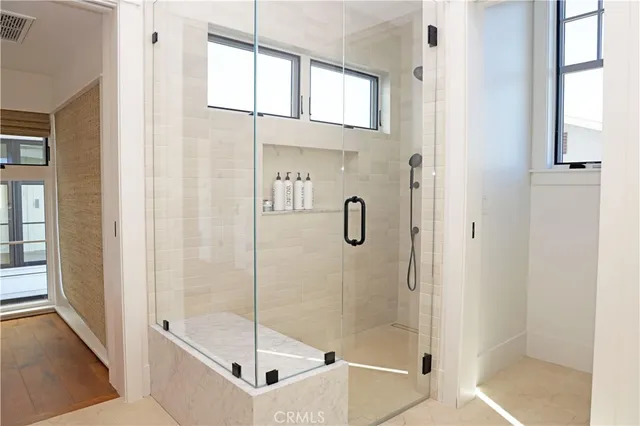 a bathroom with a glass shower door