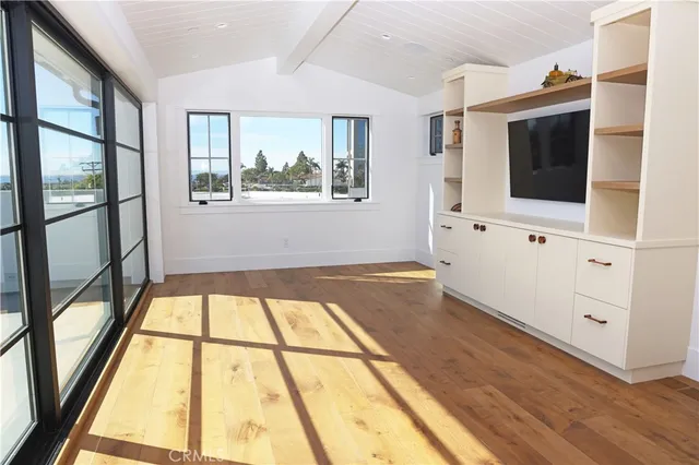 a living room with a large window and a flat screen tv