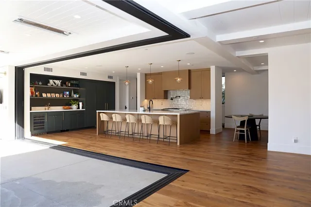 a large kitchen with a table and chairs