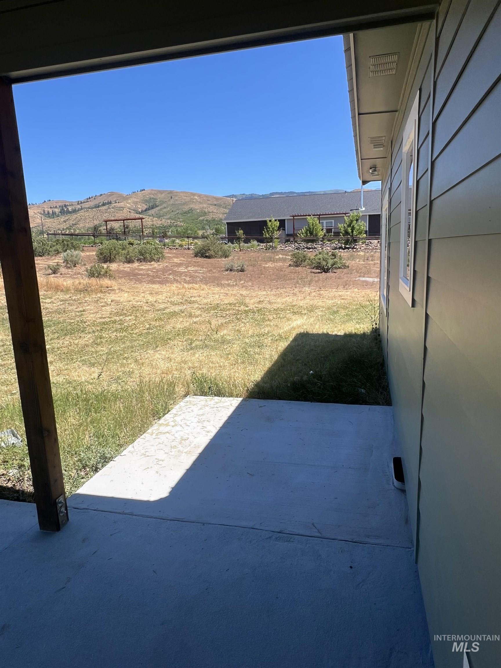 2300 Golf Council, ID 83612 - Photo 5 of 17 Covered patio area with a concrete slab, adjacent to a textured exterior siding