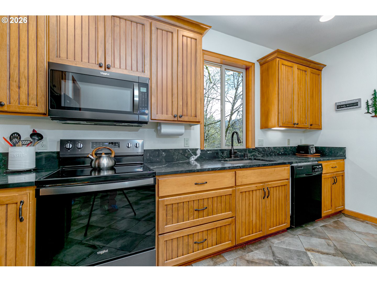 64636 Mc Intyre Road Rhododendron, OR 97049 - Photo 21 of 48 a kitchen with granite countertop a stove sink and microwave