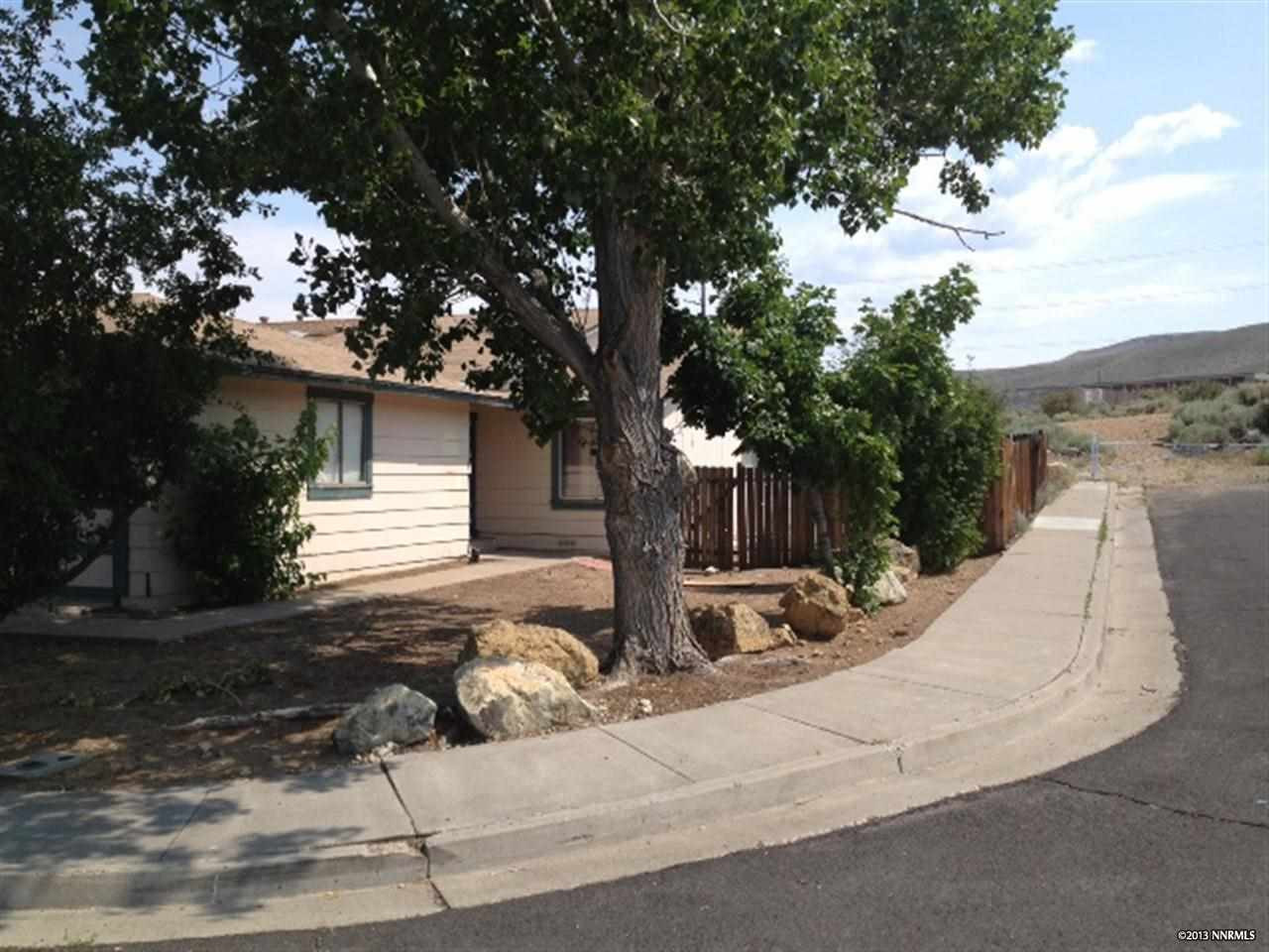 6710 Peppermint Drive Reno, NV 89506 - Photo 1 of 1 a backyard of a house with table and chairs plants and large trees