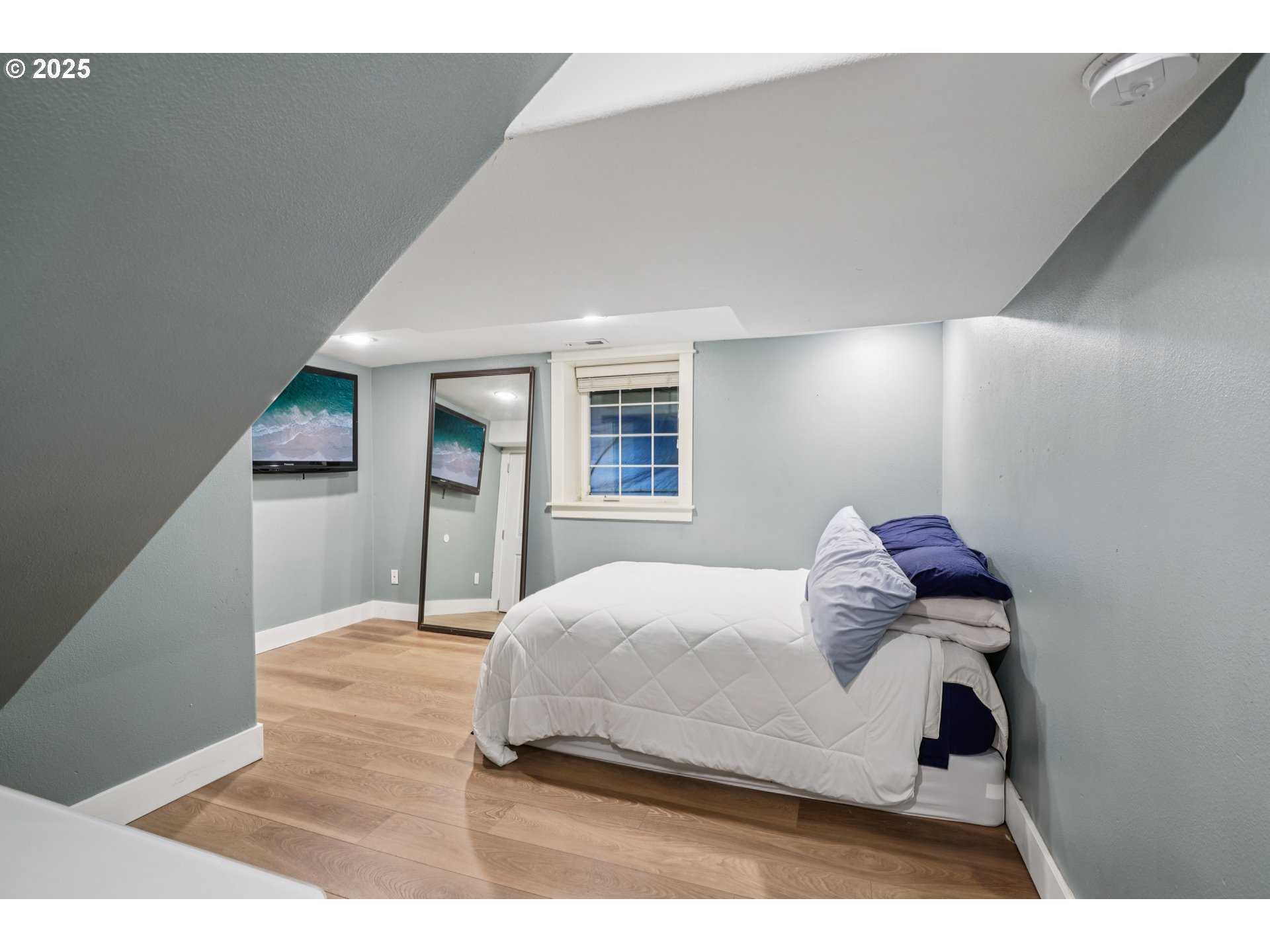 303 Maple Street Ridgefield, WA 98642 - Photo 15 of 36 a bedroom with a bed window and a flat screen tv