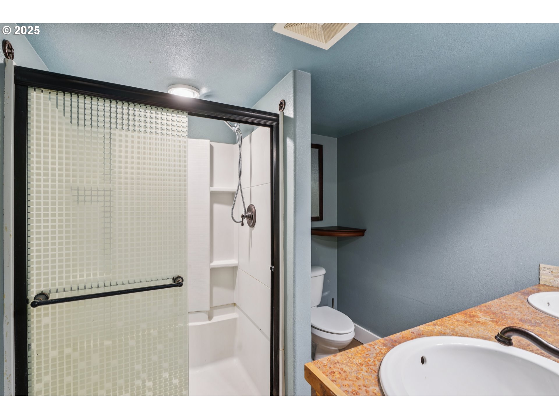 303 Maple Street Ridgefield, WA 98642 - Photo 16 of 36 a bathroom with a sink and a shower