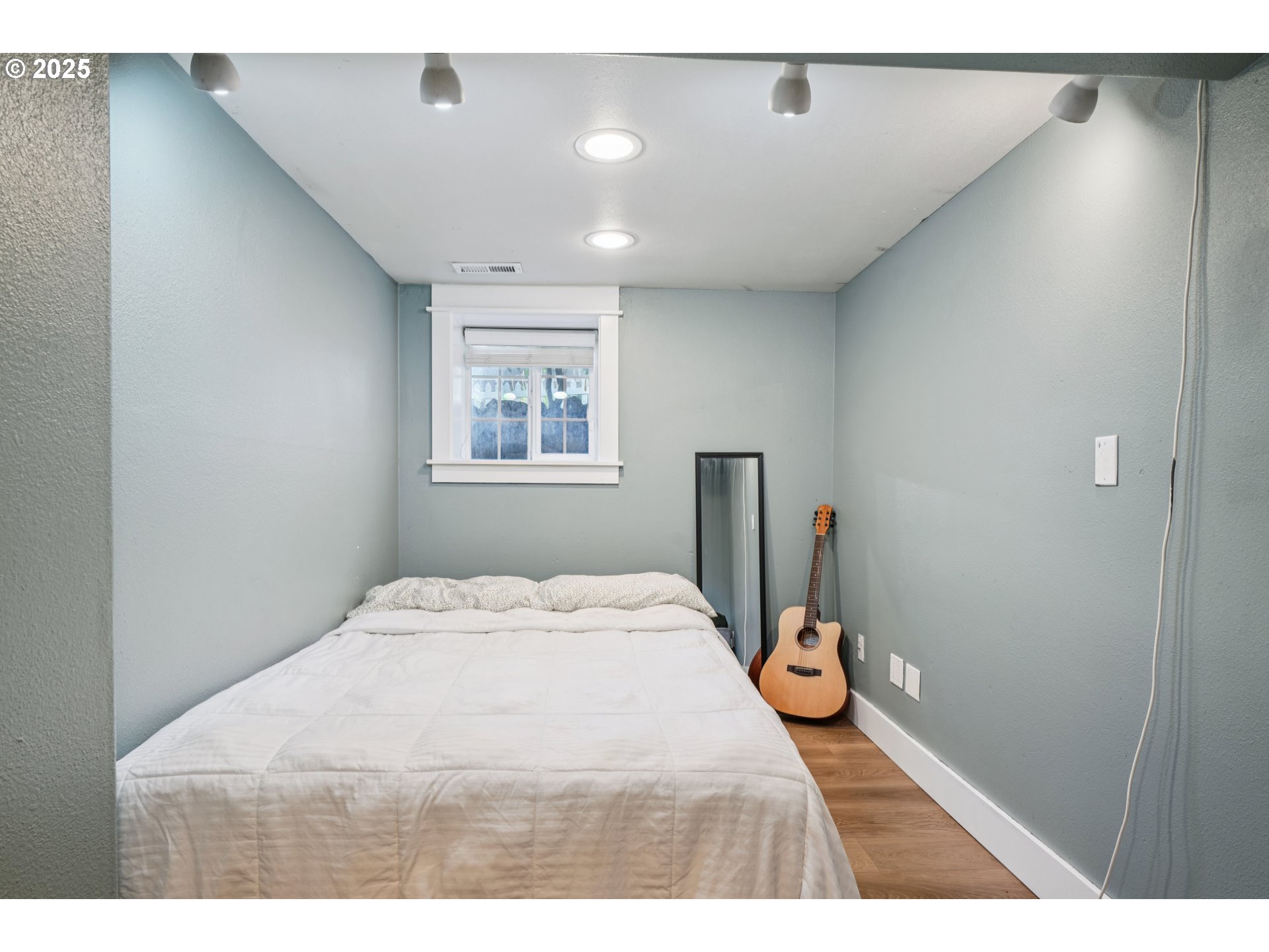 303 Maple Street Ridgefield, WA 98642 - Photo 17 of 36 a bedroom with a bed and wooden floor
