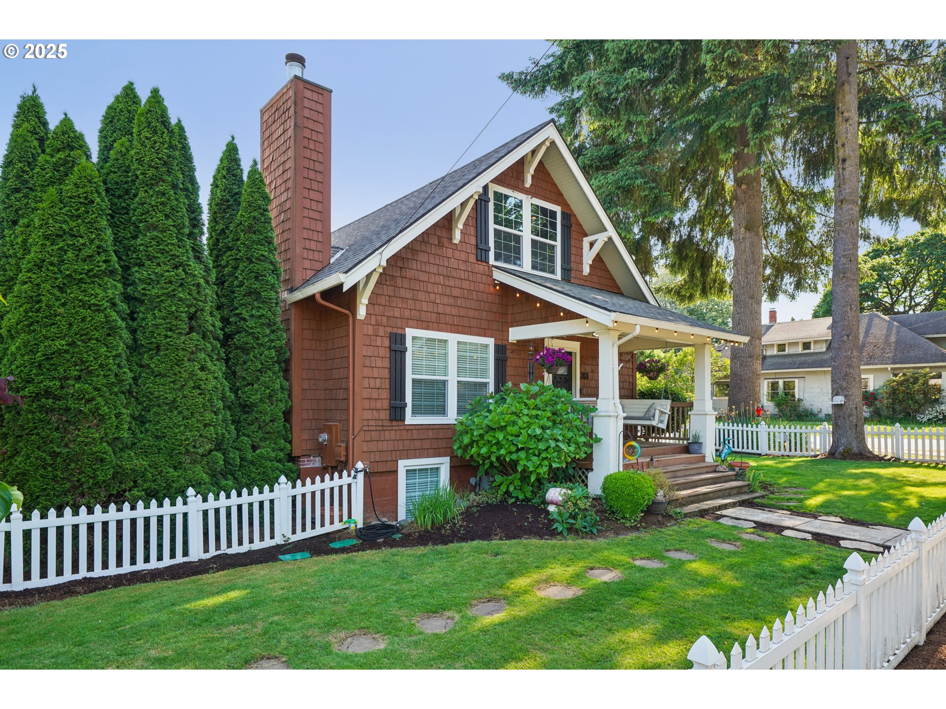 303 Maple Street Ridgefield, WA 98642 - Photo 2 of 36 a front view of a house with garden