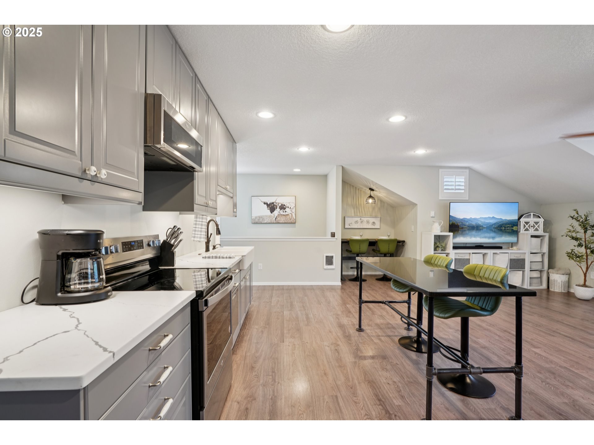 303 Maple Street Ridgefield, WA 98642 - Photo 30 of 36 a kitchen that has a lot of cabinets a sink and appliances in it