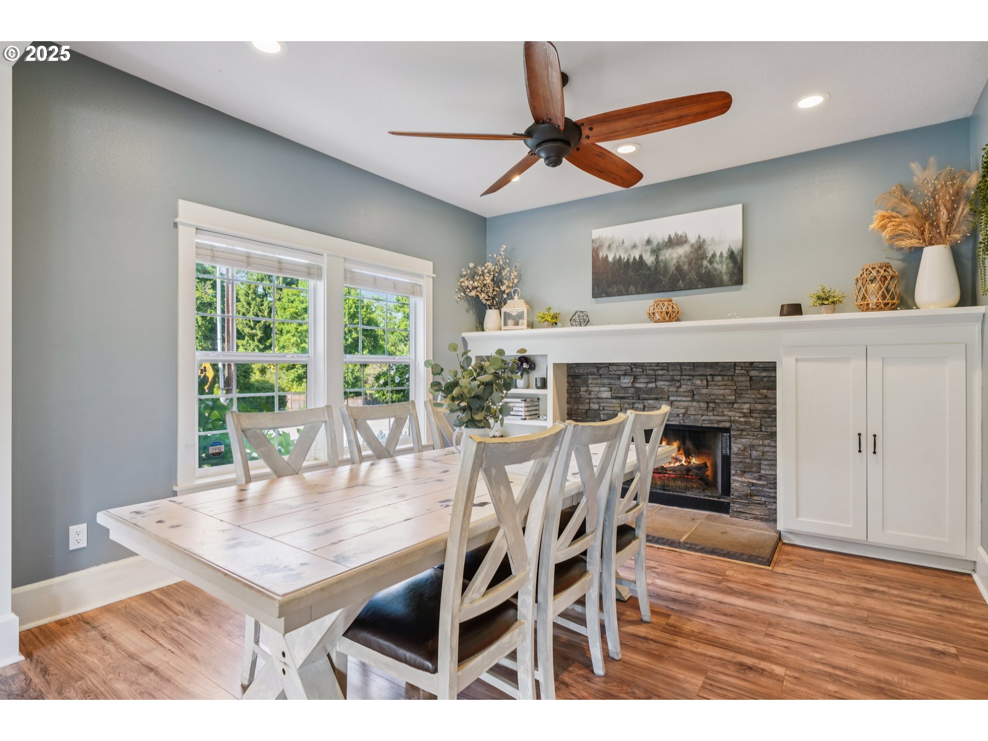 303 Maple Street Ridgefield, WA 98642 - Photo 10 of 36 a dining room with furniture a fireplace and wooden floor