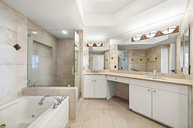 a bathroom with a granite countertop sink mirror and a bathtub