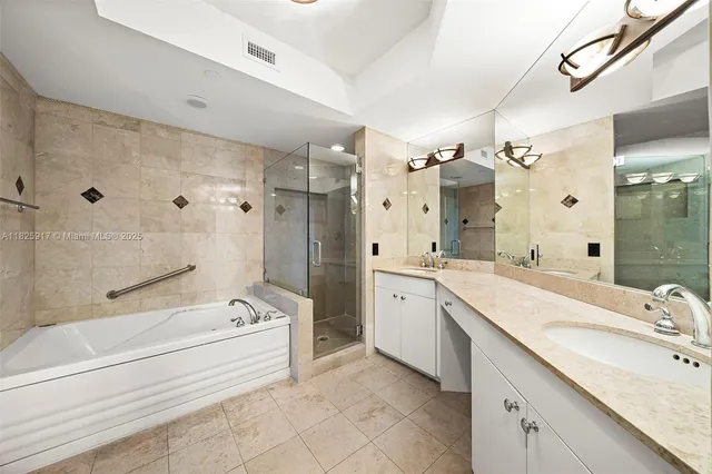 a spacious bathroom with a granite countertop tub sink double and mirror