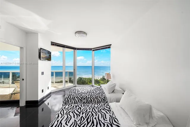 a bedroom with a bed and a large window