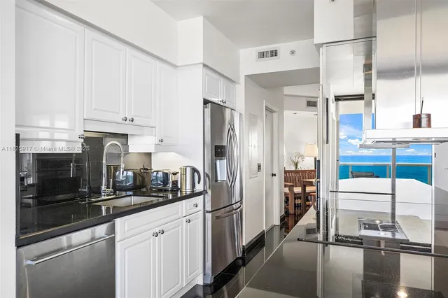 a kitchen with stainless steel appliances a refrigerator and a stove top oven