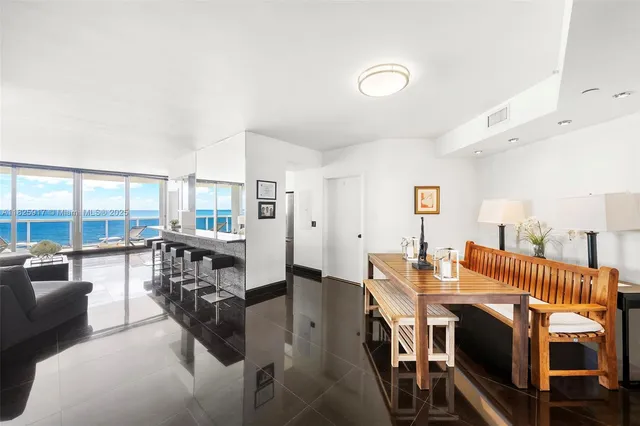 a living room with furniture and a floor to ceiling window