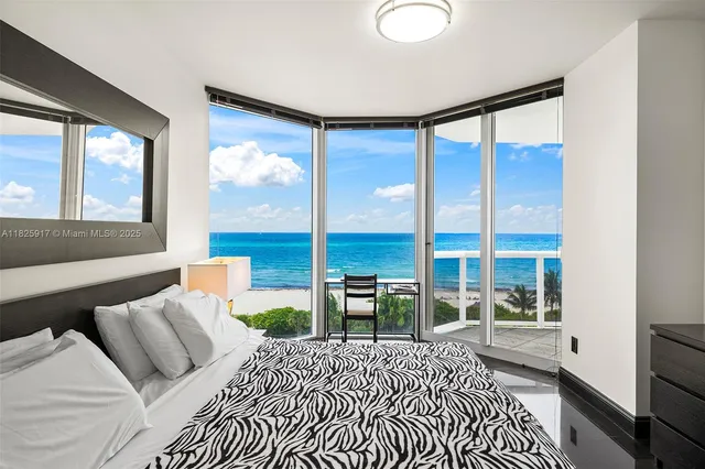 a bedroom with a large bed and a large window