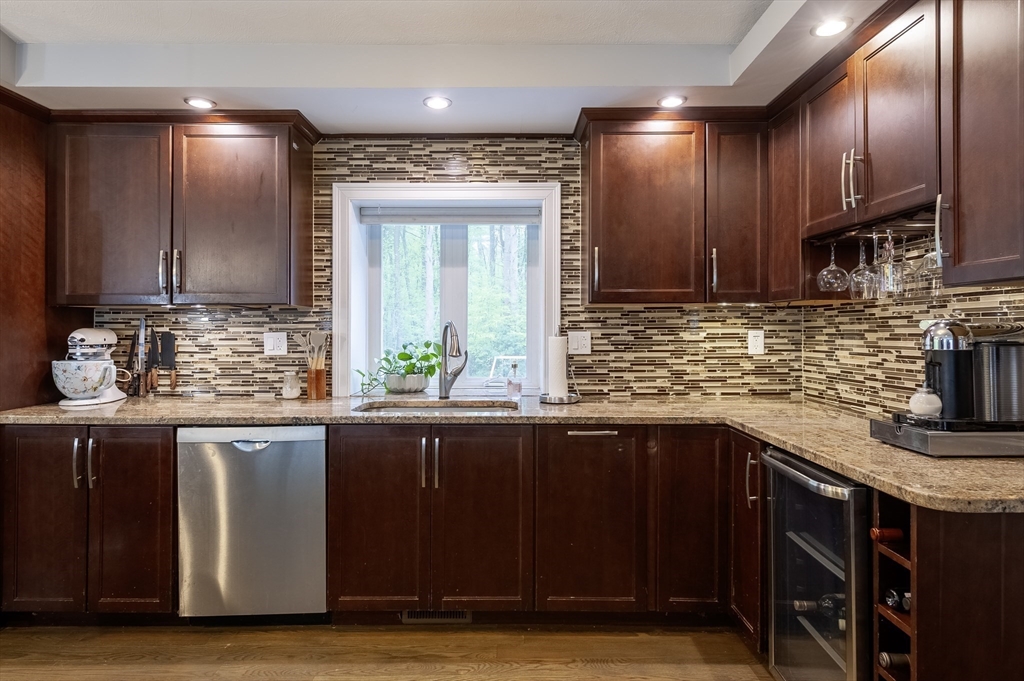 357 Ledge Road Seekonk, MA 02771 - Photo 12 of 42 a kitchen with granite countertop wooden cabinets and a sink