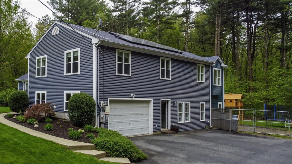 357 Ledge Road Seekonk, MA 02771 - Photo 2 of 42 a front view of a house with garden