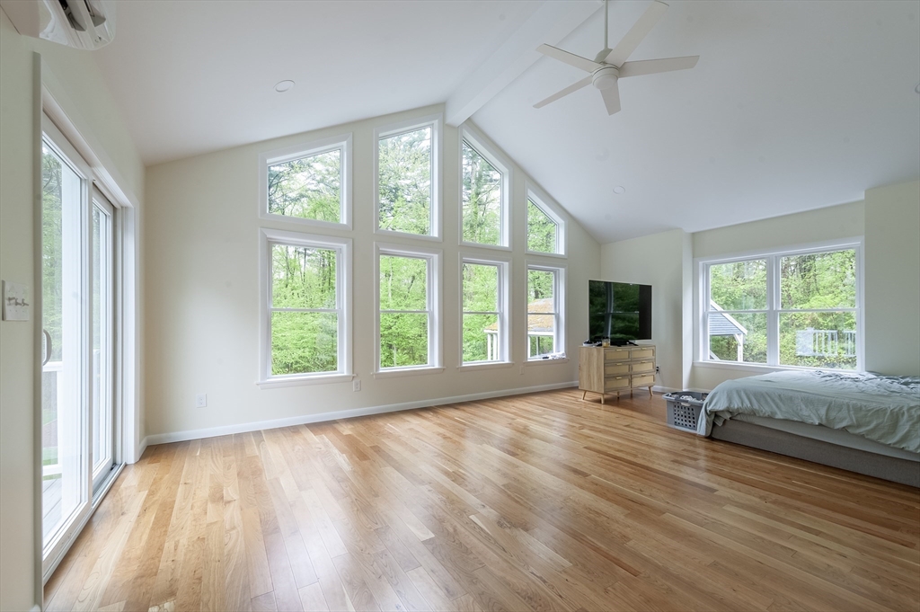 357 Ledge Road Seekonk, MA 02771 - Photo 25 of 42 a view of an empty room with a window and wooden floor