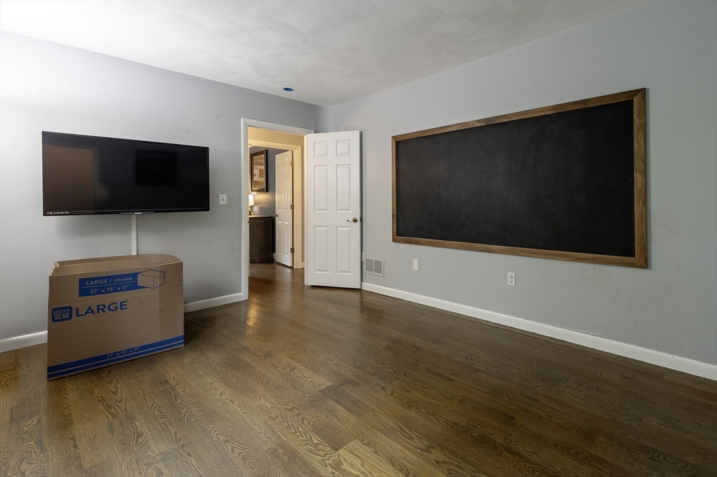 357 Ledge Road Seekonk, MA 02771 - Photo 31 of 42 a living room with furniture and a flat screen tv
