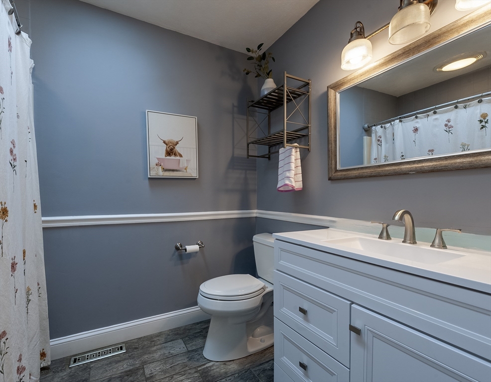 357 Ledge Road Seekonk, MA 02771 - Photo 32 of 42 a bathroom with a toilet a sink and mirror