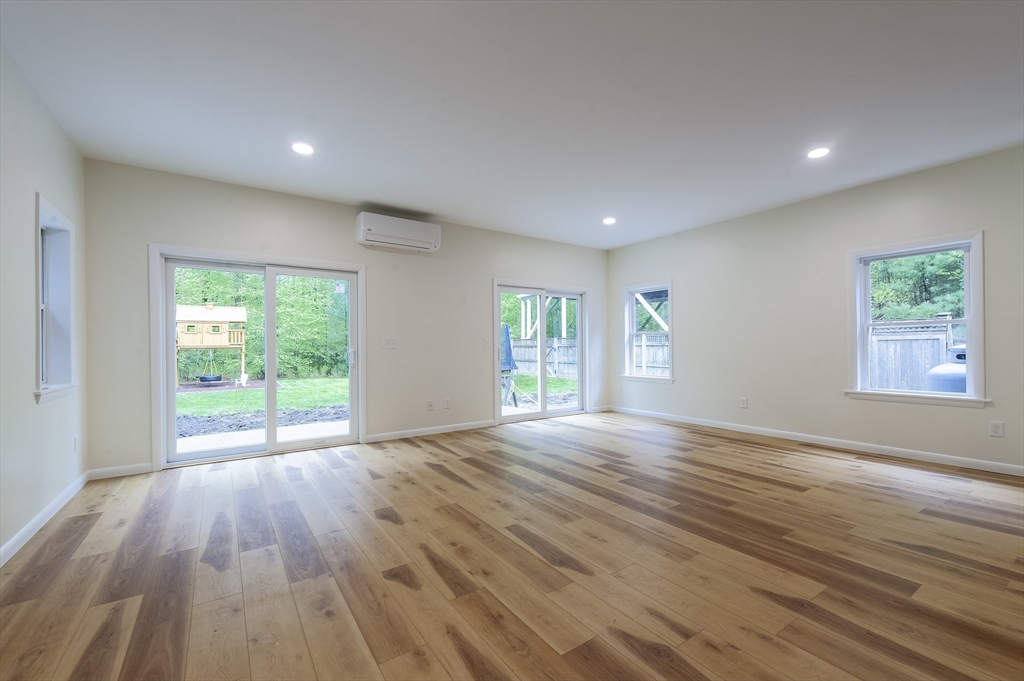 357 Ledge Road Seekonk, MA 02771 - Photo 36 of 42 a view of an empty room with wooden floor and a window