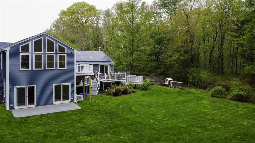 357 Ledge Road Seekonk, MA 02771 - Photo 41 of 42 a front view of a house with a yard table and chairs