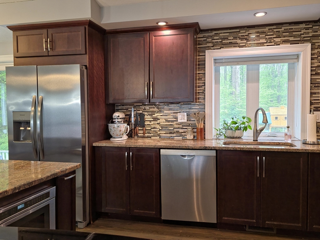 357 Ledge Road Seekonk, MA 02771 - Photo 5 of 42 a kitchen with granite countertop a sink and a refrigerator