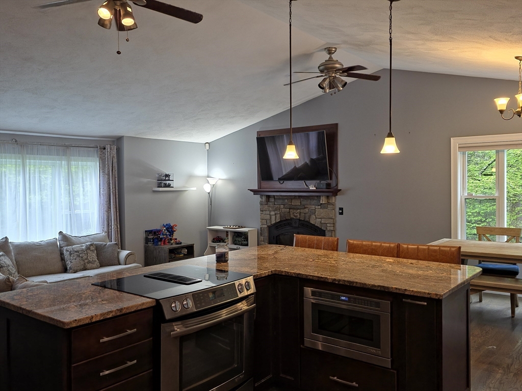 357 Ledge Road Seekonk, MA 02771 - Photo 7 of 42 a kitchen with a stove a sink and a fireplace