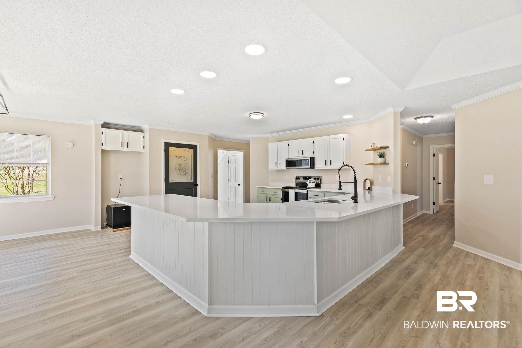 35650 Spring Road North Stapleton, AL 36578 - Photo 28 of 70 Kitchen with ornamental molding, a peninsula, recessed lighting, white cabinets, and light wood-type flooring
