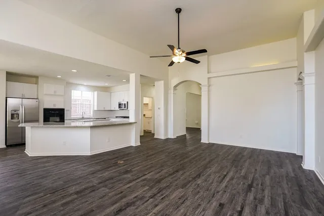 a view of kitchen and hall with wooden floor