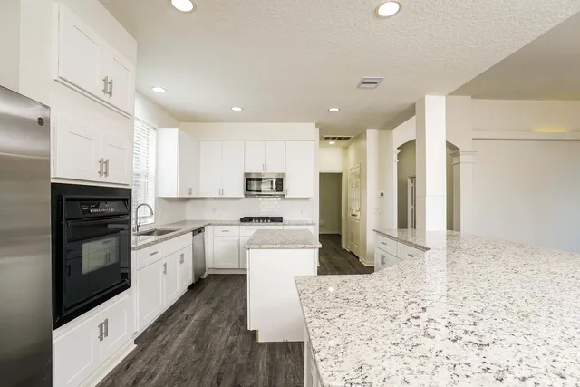 a large kitchen with cabinets