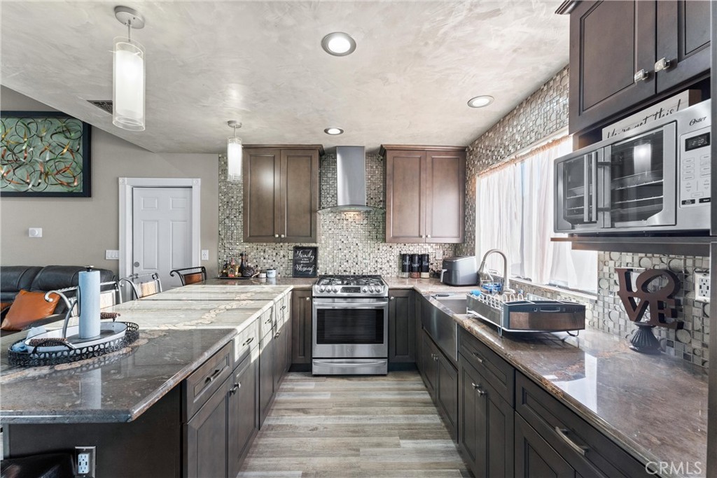 4254 Manx Court Riverside, CA 92503 - Photo 12 of 38 a kitchen with a sink stove top oven and cabinets