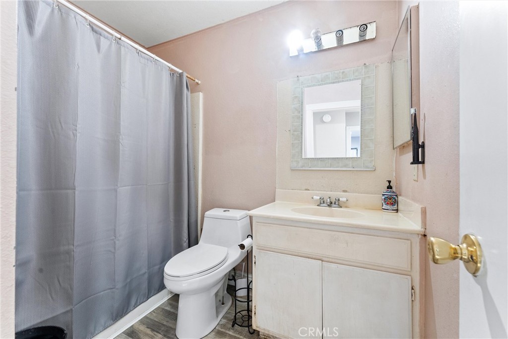 4254 Manx Court Riverside, CA 92503 - Photo 14 of 38 a bathroom with a sink a toilet and mirror
