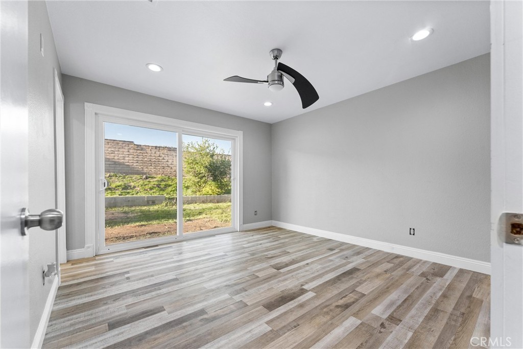 4254 Manx Court Riverside, CA 92503 - Photo 15 of 38 a view of an empty room with wooden floor and a window