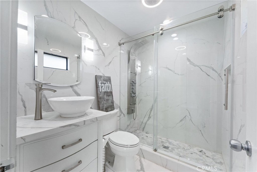 4254 Manx Court Riverside, CA 92503 - Photo 17 of 38 a bathroom with a sink toilet and shower