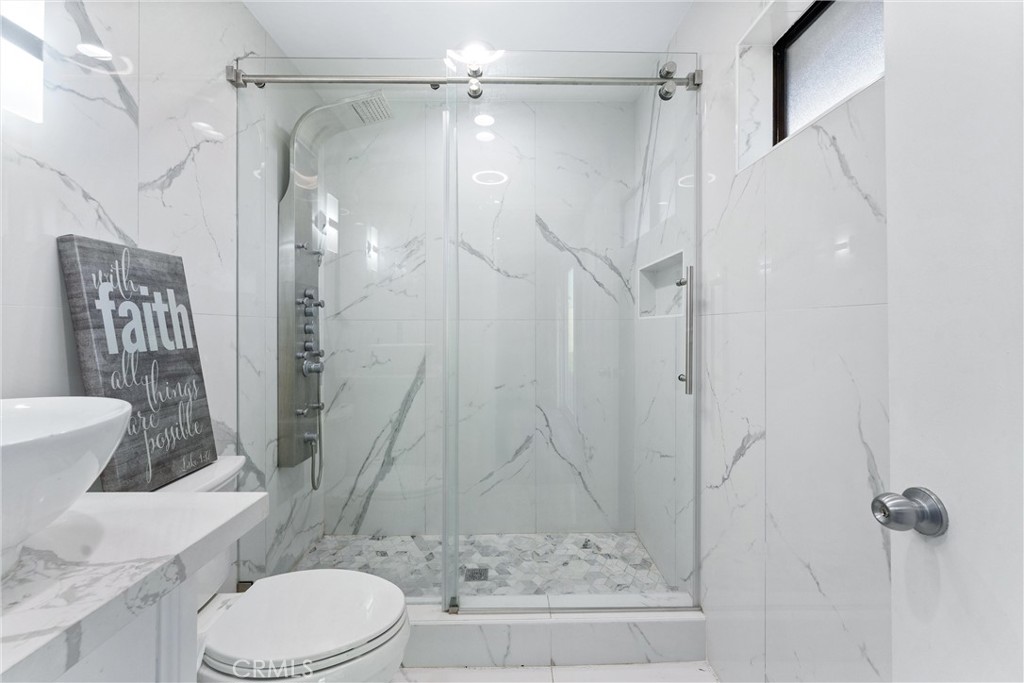 4254 Manx Court Riverside, CA 92503 - Photo 18 of 38 a white toilet sitting next to a shower