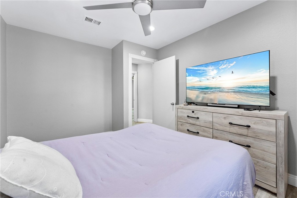 4254 Manx Court Riverside, CA 92503 - Photo 20 of 38 a bedroom with a bed and a flat screen tv
