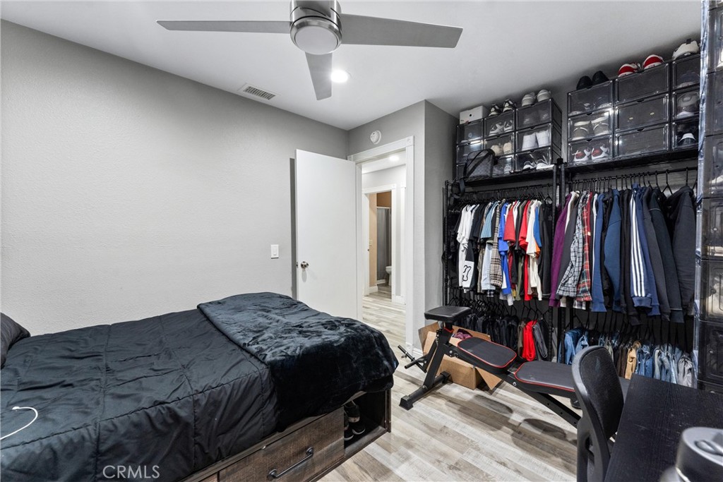 4254 Manx Court Riverside, CA 92503 - Photo 22 of 38 a bedroom with a bed a standing and book shelf