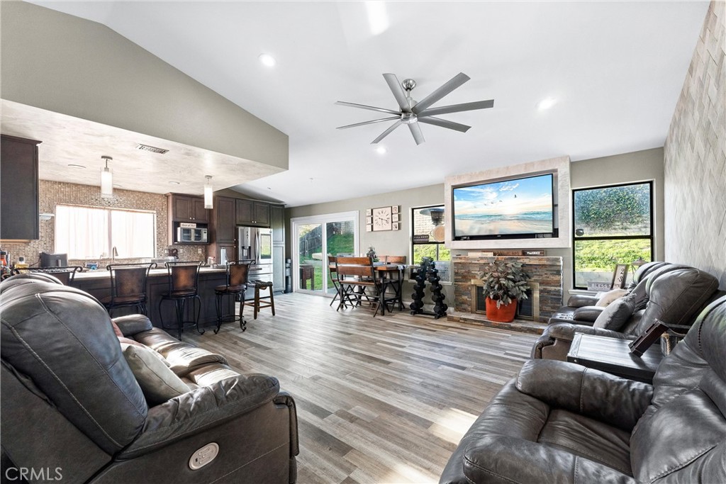 4254 Manx Court Riverside, CA 92503 - Photo 4 of 38 a living room with furniture and a flat screen tv with wooden floor