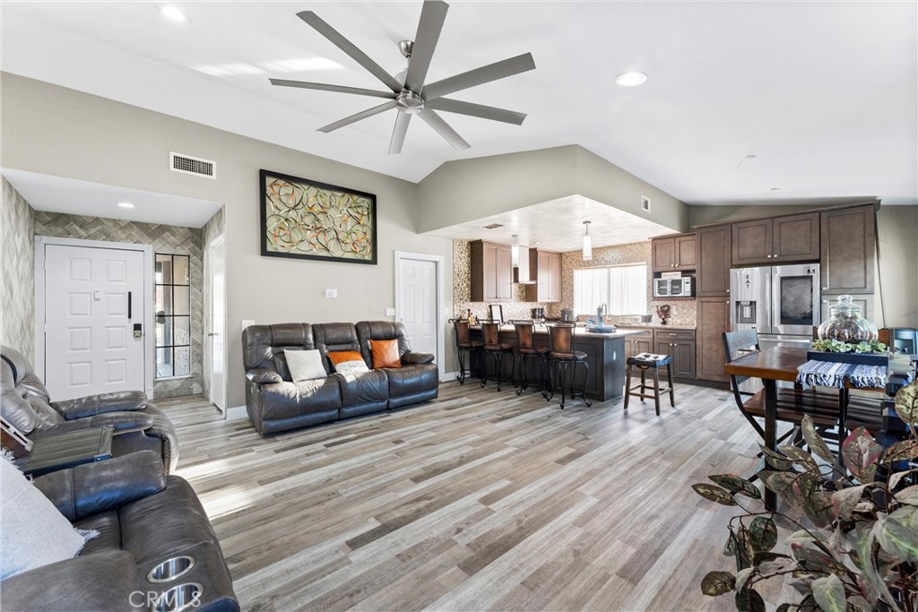 4254 Manx Court Riverside, CA 92503 - Photo 7 of 38 a living room with furniture kitchen view and a wooden floor