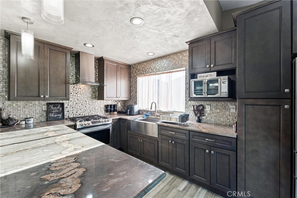 4254 Manx Court Riverside, CA 92503 - Photo 10 of 38 a kitchen with a sink stove and cabinets