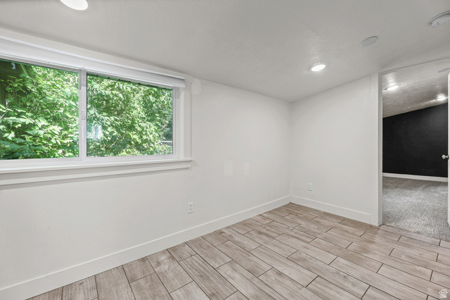 175 North 700 East Springville, UT 84663 - Photo 20 of 32 Bright interior space featuring a large window with white trim, wood-finish flooring, recessed ceiling lights, and white baseboards