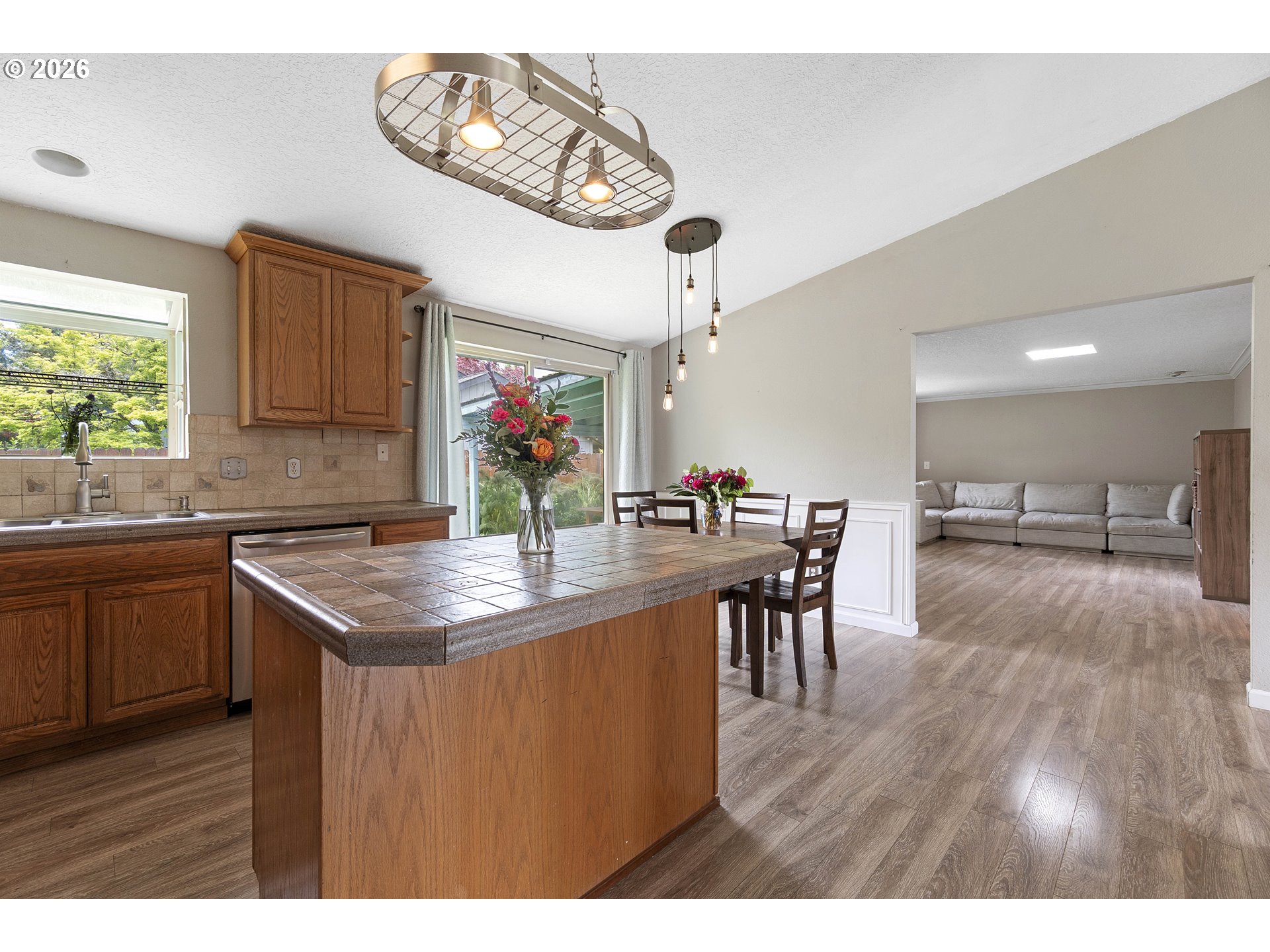 6749 Southwest 174th Place Beaverton, OR 97007 - Photo 15 of 39 a kitchen with stainless steel appliances granite countertop a sink dishwasher a stove with wooden floor