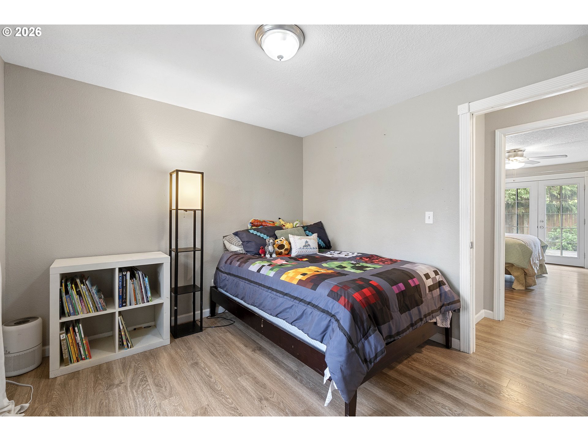 6749 Southwest 174th Place Beaverton, OR 97007 - Photo 27 of 39 a bedroom with a bed and wooden floor