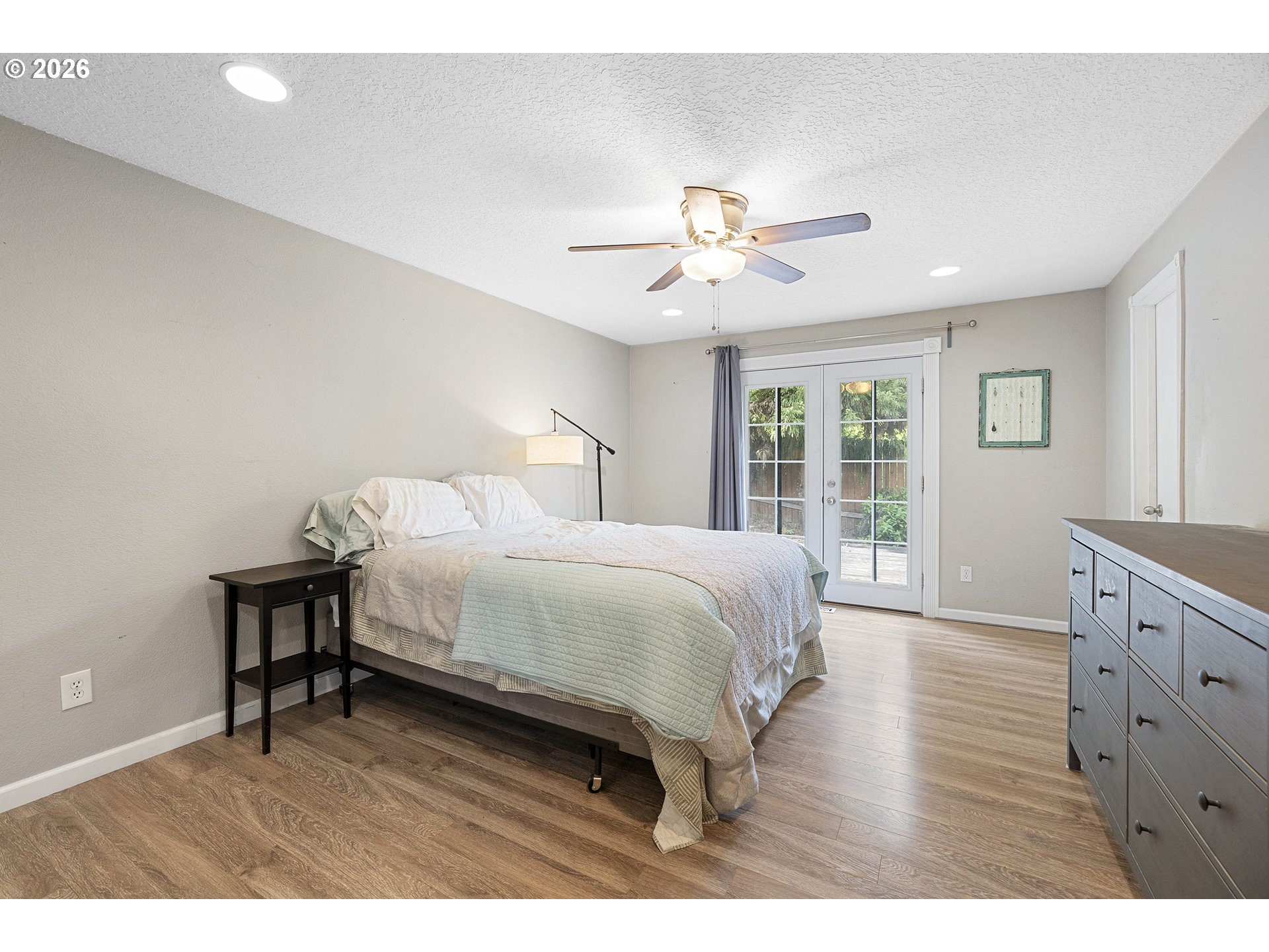 6749 Southwest 174th Place Beaverton, OR 97007 - Photo 29 of 39 a spacious bedroom with a bed and a chandelier