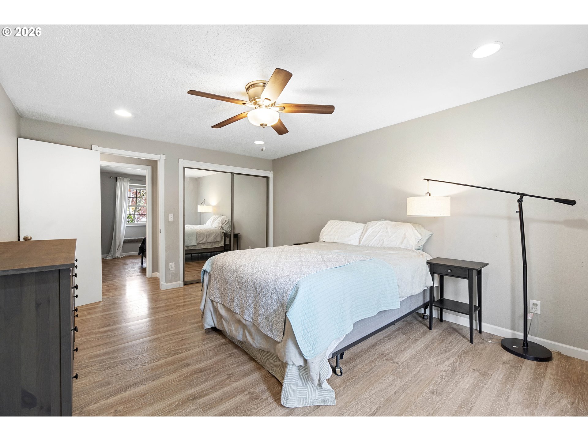 6749 Southwest 174th Place Beaverton, OR 97007 - Photo 30 of 39 a bedroom with a bed and a chandelier