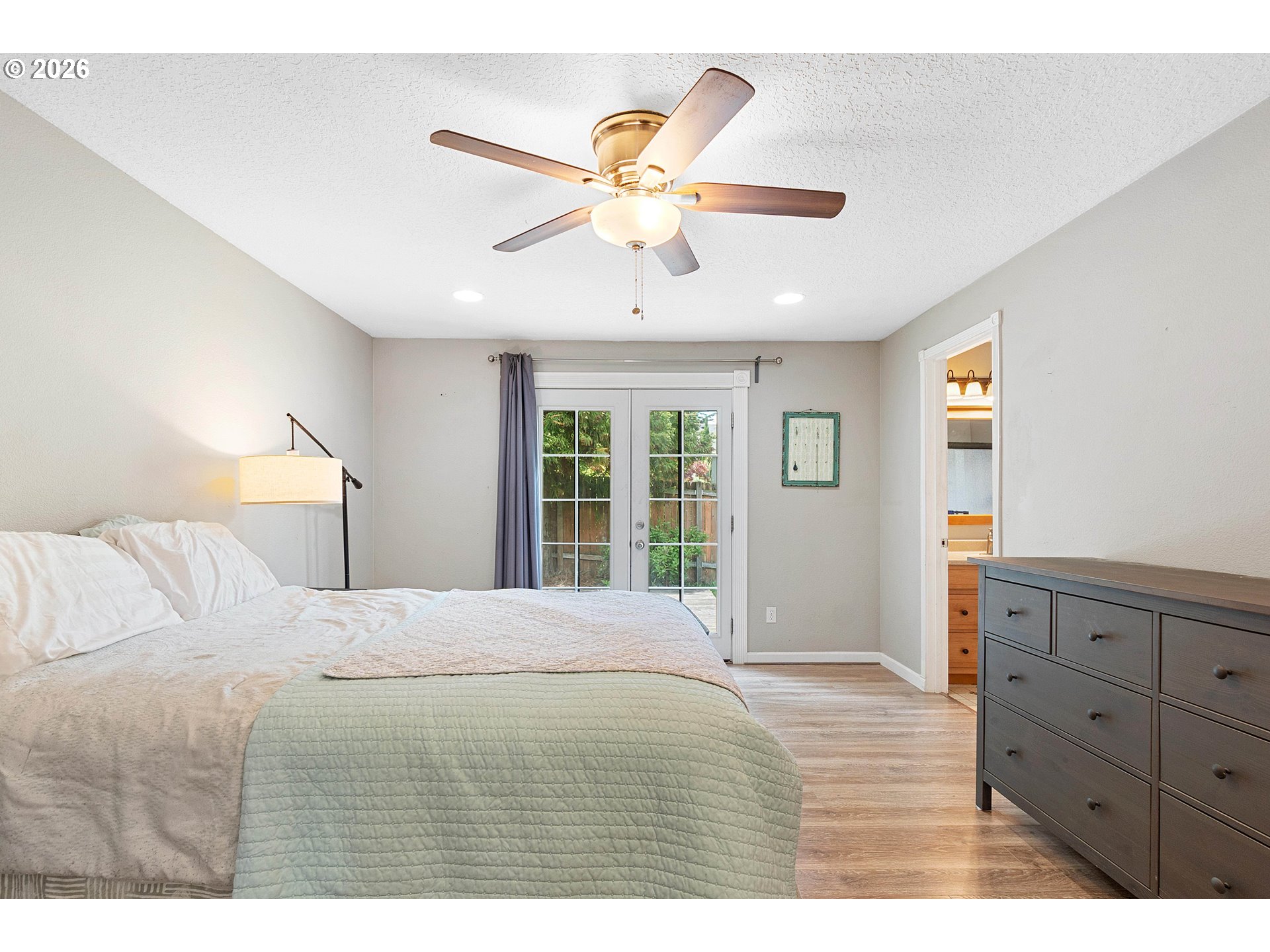 6749 Southwest 174th Place Beaverton, OR 97007 - Photo 31 of 39 a bedroom with a bed and a chandelier